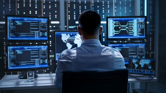 person with multiple computer screens