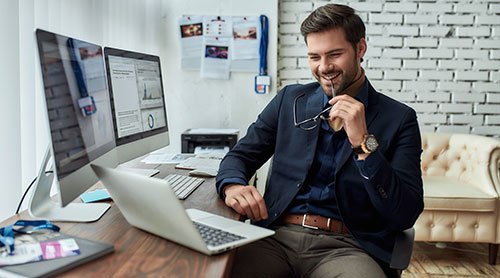 Man working and holding his glasses