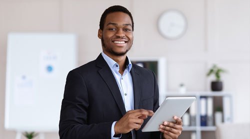 Man smiling holding a tablet